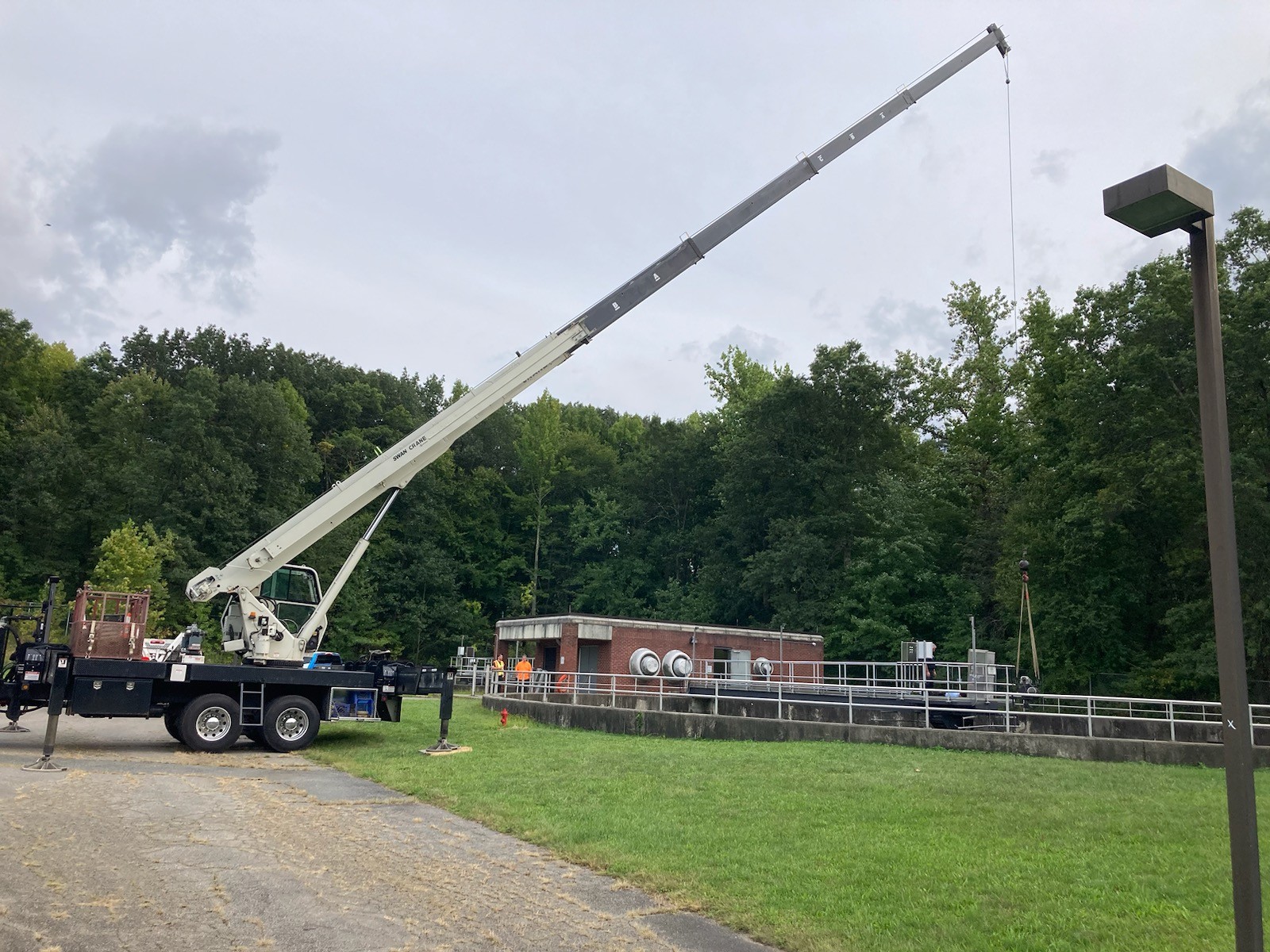 Swan Crane Service Rental Crane In Operation on Construction Site Lifting Heavy Load
