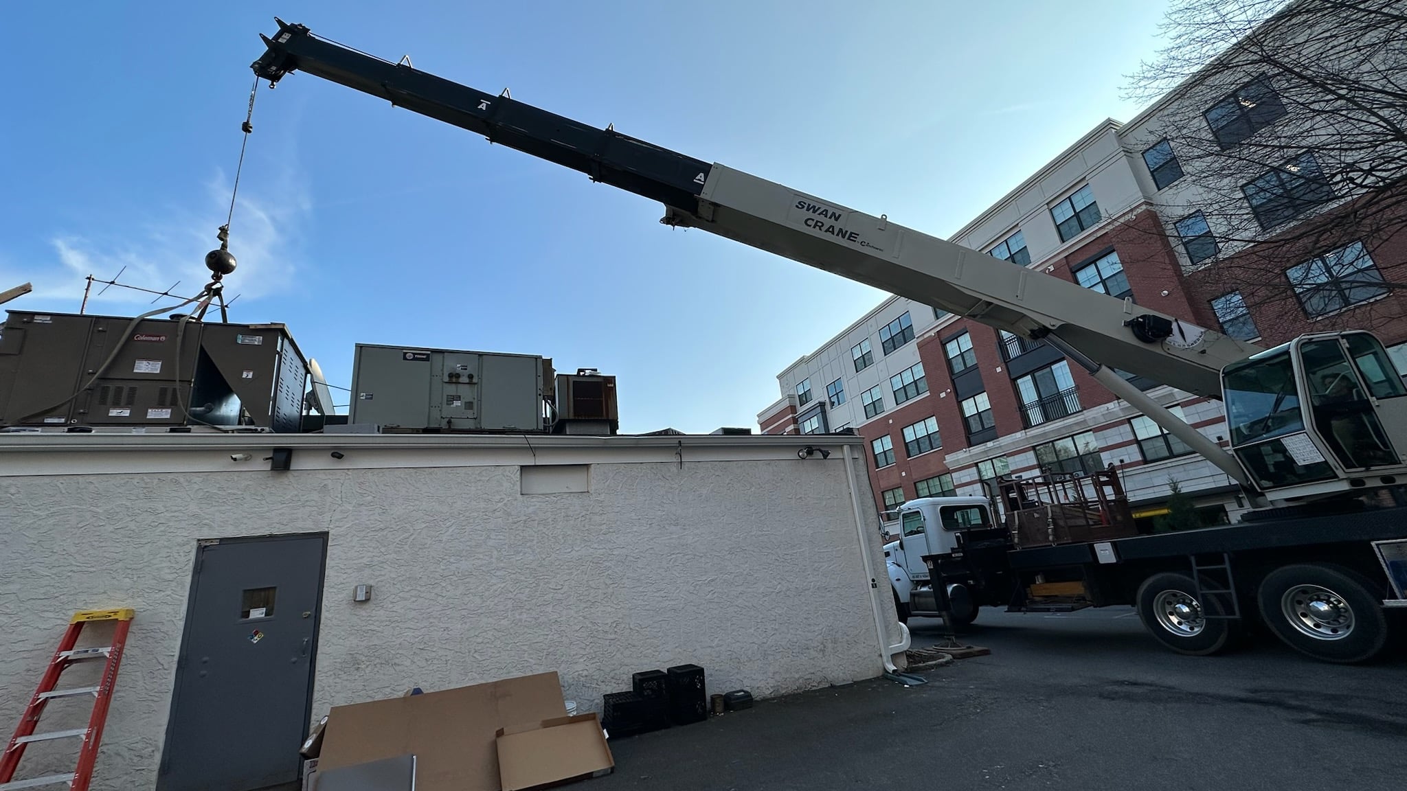 Swan Crane Service using National crane to replace HVAC Unit