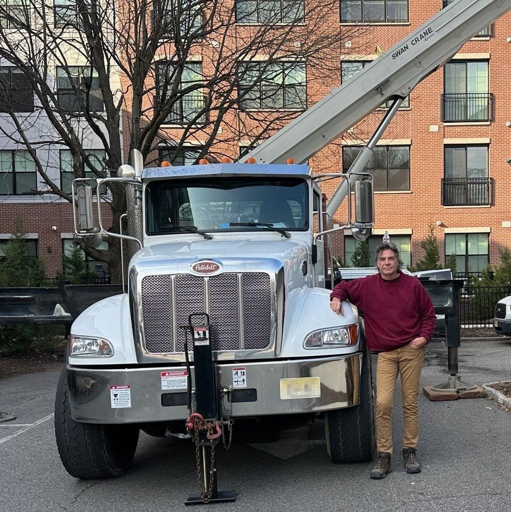 Owner/Operator Dave Swan posing with 35 ton crane available for rental